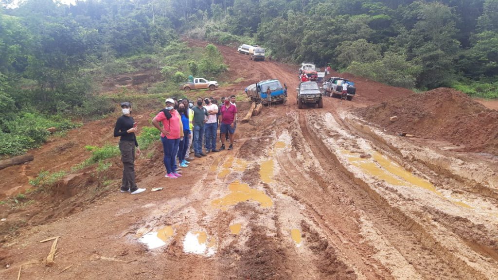 Ministers, Hon. Pauline Sukhai and Hon. Vickram Bharrat stands at the edge of a deplorable road in Mahdia, Region Eight 