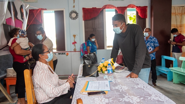 A resident engages Minister of Amerindian Affairs, Ms. Pauline Sukhai on the GOAL scholarships