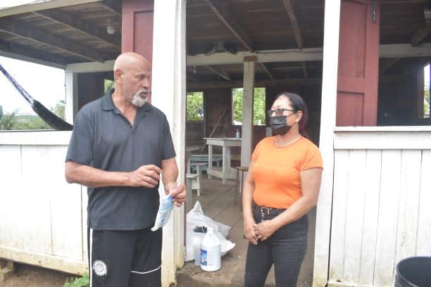 Directly affected resident, Mr. Raphiel Davis speaking with Hon. Minister Pauline Sukhai.