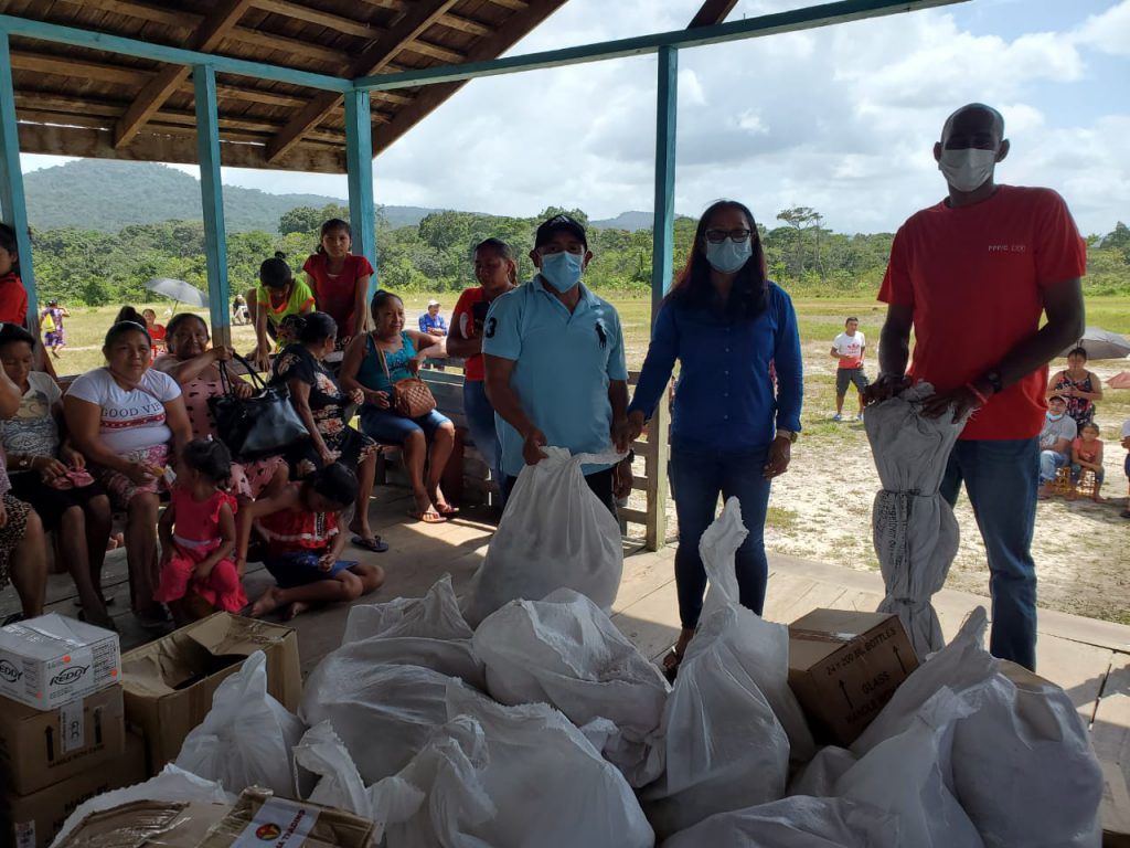 Minister of Amerindian Affairs, Pauline Sukhai handing over hampers for the flood-affected residents of Chenapou, Region Eight.