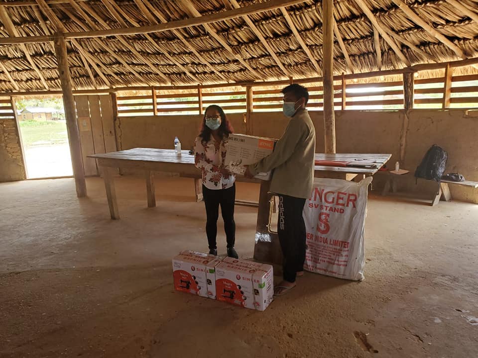 Handing over of two brand new sewing machines and a chain saw to Senior Councillor of Chiung Mouth, Denis Williams by Minister Pauline Sukhai