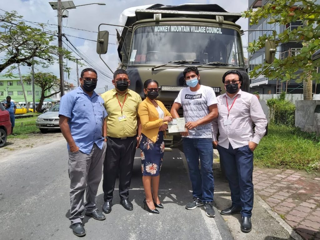 Permanent Secretary, Sharon Hicks hands over the keys to Toshao Lincoln Singh of Monkey Mountain for the new truck