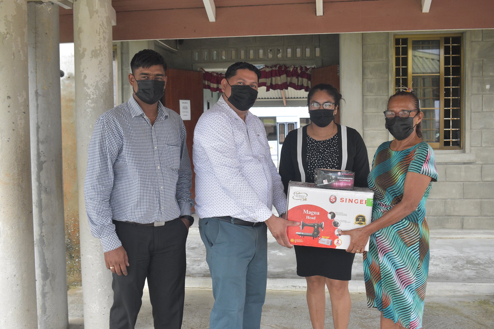 Deputy Permanent Secretary, Ryan Toolsiram handing over the tools and equipment to Toshao Yvonne Pearson in the presence of Parliamentary Secretary Sarah Browne and Project Coordinator Besham Ramsaywack