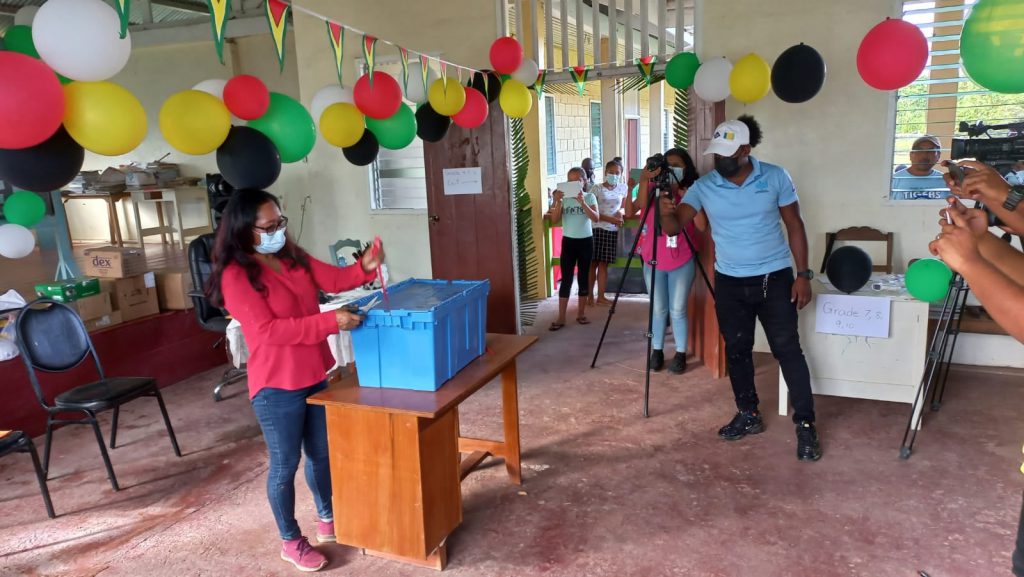 Minister of Amerindian Affairs, Pauline Sukhai, MP, opens the box to start the distribution.