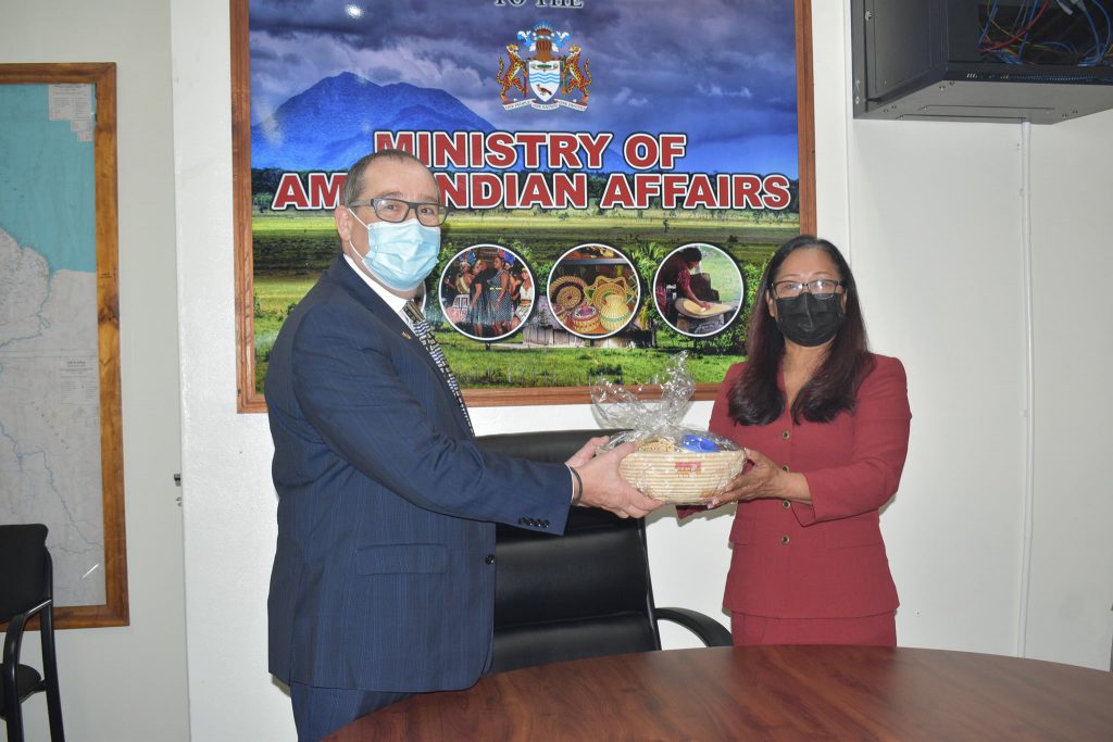 Hon. Minister Pauline Sukhai presents High Commissioner H.E Mark Berman with a token.