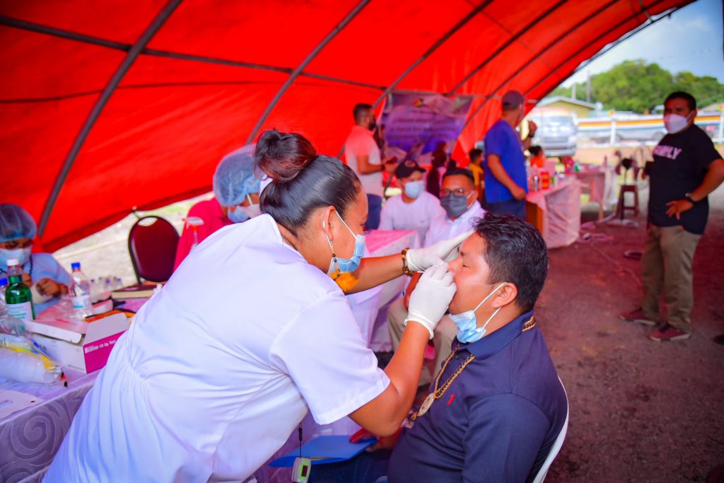 A Health-care provider conducts a COVID-19 PCR on a Toshao at the Regional Toshaos Meetings in Lethem, Region Nine