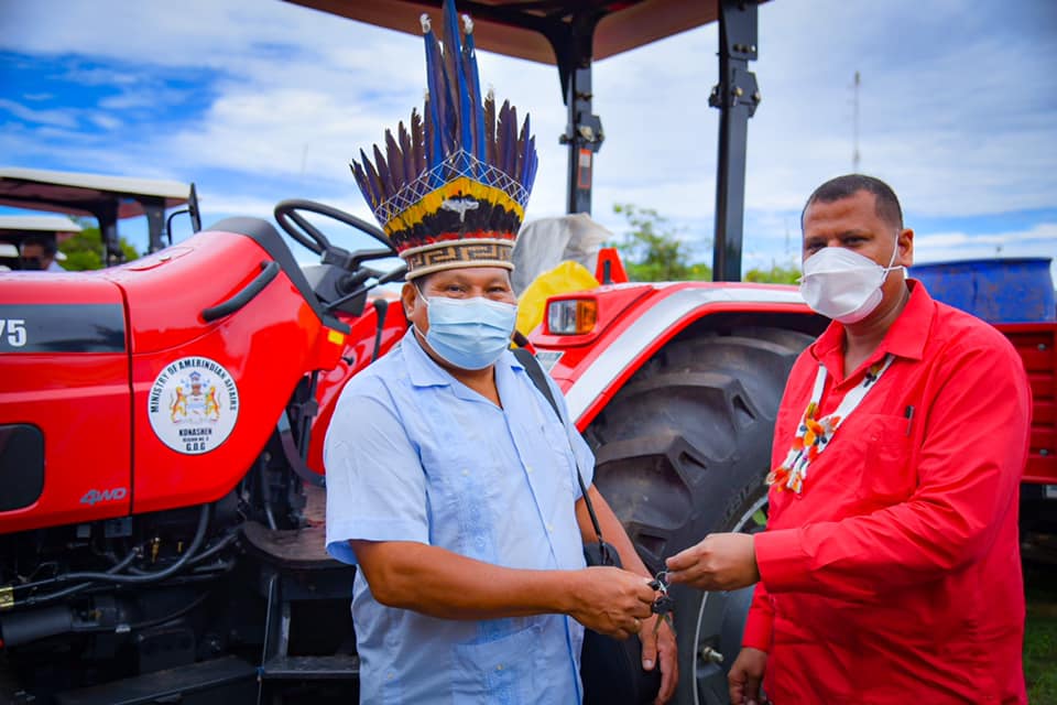 Minister of Housing and Water, Hon. Collin Croal hands over the tractor keys to a Toshao