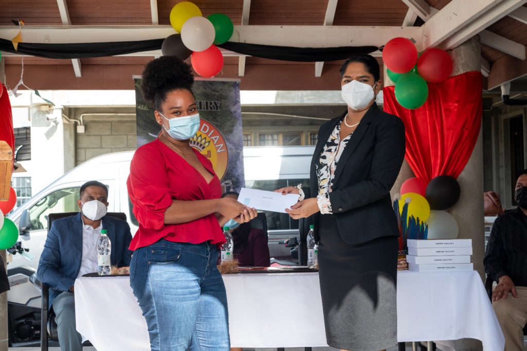 A participant, Sussana Augustin being presented with her consolation prize by Hon. Minister of Public Service, Sonia Parag