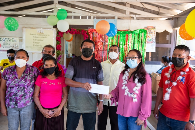 Minister of Amerindian Affairs, Pauline Sukhai, MP handing over the cheque to the village council.